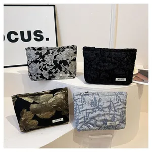 Detail view of stylish floral fabric cosmetic bag, large capacity makeup pouch for women.