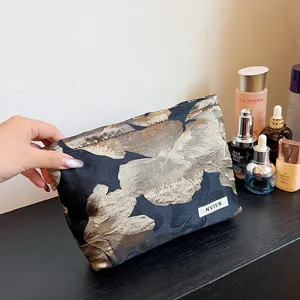 Floral jacquard cosmetic bag with large capacity, elegant fabric makeup pouch for women.