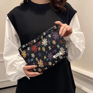 Detailed view of the woven floral cosmetic bag featuring unique ethnic jacquard texture.