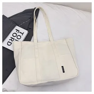 Canvas tote bag detail view, large capacity casual shoulder bag with dual straps and front pockets.