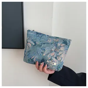 Vintage floral fabric cosmetic bag detail view, retro pattern zipper pouch for women daily use.