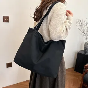 Large capacity black canvas tote bag for women, simple casual shoulder shopping bag.