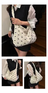 Korean style canvas shoulder tote bag featuring cute black bow print for women daily use.