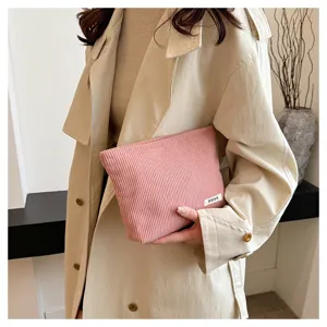 Pink corduroy makeup bag for women, stylish portable zipper clutch pouch for daily travel use.