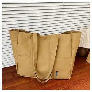 Canvas tote bag detail, large capacity shoulder bag showing front pockets and dual straps.