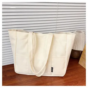 Canvas tote bag detail view, minimalist cream design, large capacity for daily use.