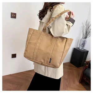 Detailed view of a Japanese style large capacity canvas tote bag in khaki, perfect for students.