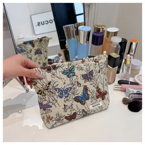 Vintage linen makeup bag with colorful butterfly pattern, stylish cosmetic pouch for women.