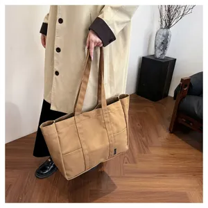 Large capacity canvas tote bag for women, stylish casual shoulder handbag with pockets.