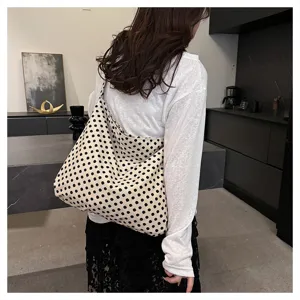 Detailed view of a casual polka dot slouchy shoulder bag with soft texture and chic look.