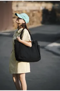Classic black canvas tote bag for women, large capacity casual shoulder bag daily use.