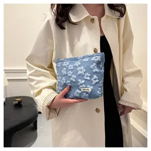 Portable blue floral cosmetic storage bag, large capacity stylish canvas makeup pouch.