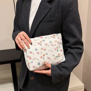Floral lace cosmetic bag for women, stylish clutch purse for daily use and travel storage.
