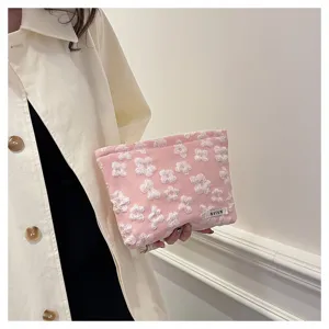 Pink floral cosmetic bag detail, soft quilted pouch for makeup, portable travel organizer.