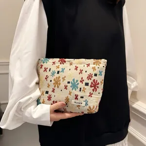 Canvas floral cosmetic bag portable storage pouch for travel and daily organization use.