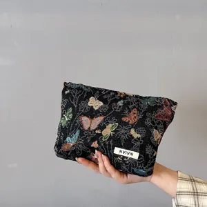 Women fabric cosmetic bag with colorful butterfly pattern, stylish makeup pouch for daily use.