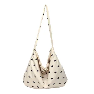 Casual canvas shoulder tote bag with cute black bow prints for women daily use main view.