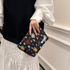 Detailed view of the woven floral makeup pouch, portable storage bag for travel use.