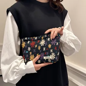Linen jacquard cosmetic bag detail, colorful floral pattern pouch, portable travel storage.