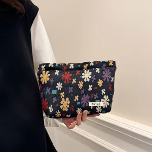 Woven floral cosmetic bag, portable makeup pouch and travel storage organizer for daily use.