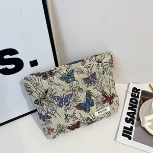 Canvas cosmetic bag with colorful butterfly pattern, large capacity storage pouch for women.