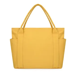 Yellow canvas tote bag side pocket detail close up view daily casual handbag chic