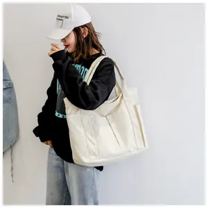 Canvas tote bag for women, large capacity stylish casual shoulder bag with multiple outer pockets.