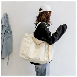 Large capacity canvas shoulder bag for women, stylish tote bag with multiple pockets.