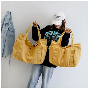 Korean style large capacity canvas tote bag for women, multi-pocket casual shoulder bag.