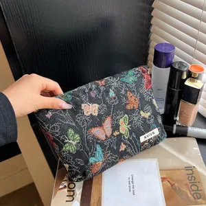 Black woven cosmetic bag with colorful butterfly pattern, large capacity zipper storage pouch.