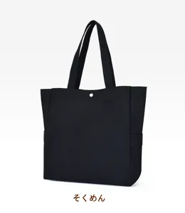 Black canvas tote bag side detail view, casual minimalist shoulder handbag for daily use.
