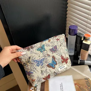 Woven cosmetic bag with colorful butterfly pattern, stylish large capacity makeup pouch.