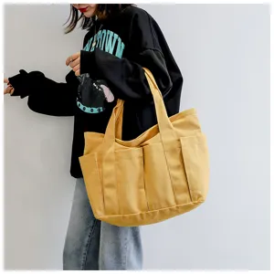 Yellow canvas tote bag with multiple pockets for women casual daily use and travel detail view