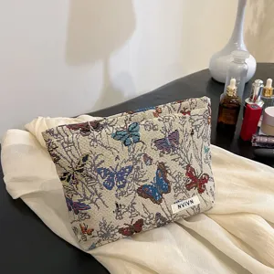 Detailed view of the woven butterfly cosmetic pouch featuring intricate fabric texture and large capacity.
