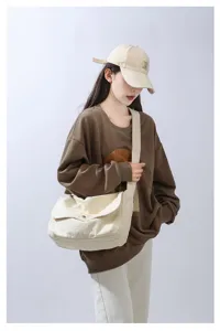 Minimalist canvas messenger bag for daily wear, casual crossbody shoulder bag with wide strap.