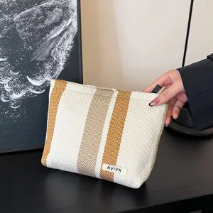 Striped canvas cosmetic bag, large capacity travel pouch, portable makeup organizer for women.