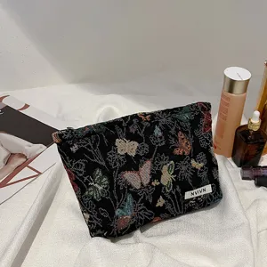 Women's woven cosmetic bag with butterfly pattern, large capacity daily makeup storage pouch.