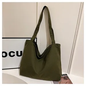 Dark green canvas tote bag detail view, casual minimalist shoulder bag for daily use.