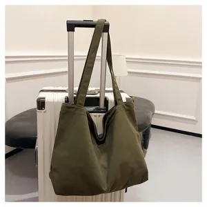 Dark green canvas tote bag detail view, casual shoulder bag for women daily commute style