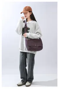 Minimalist canvas messenger bag for daily commuting, casual shoulder crossbody bag for students.