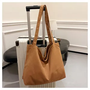 Canvas tote bag for women, large capacity shoulder shopping bag in solid brown color detail view.