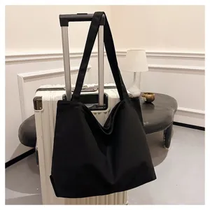 Black canvas tote bag for women, casual shoulder shopping bag with large capacity daily use.