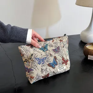 Detailed view of a vintage butterfly woven cosmetic makeup pouch with a handy zipper closure.