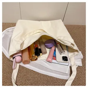 Large capacity canvas tote bag showcasing daily essentials and cosmetics storage inside neatly.