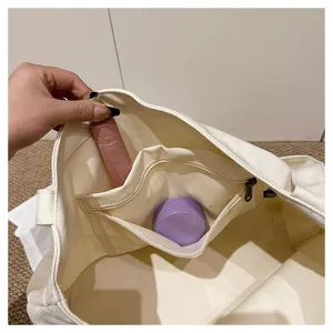 Korean style canvas tote bag interior detail showing spacious compartment and zipper pocket.