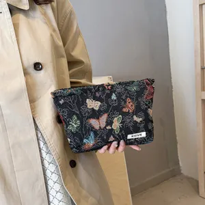 Woven tapestry cosmetic bag with colorful butterfly pattern, vintage portable makeup pouch.