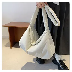 Detailed shot of a soft white puffer tote bag, lightweight padded cloud design for daily commute.