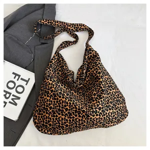 Close-up detail shot of the casual leopard print canvas tote bag in daily styling setup.