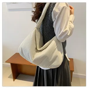 Detail view of the casual quilted shoulder tote bag, large capacity daily commuter handbag.