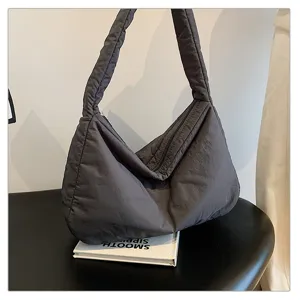 Detailed view of padded shoulder bag, casual dark grey hobo design for daily commuting use.